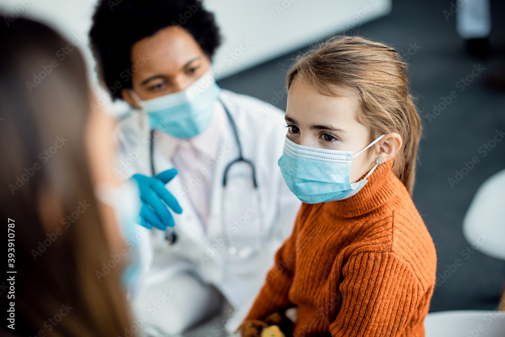 Little girl wearing protective face mask while being at medical clinic. Little girl wearing protective face mask while being at medical clinic.