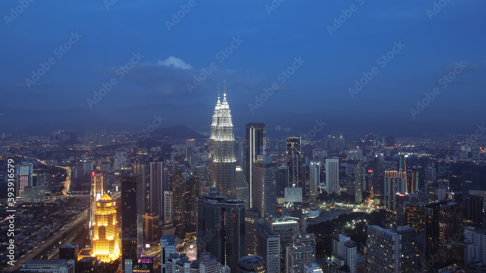 Petronas Towers, colorful vibrant twilight after sunset.
Panoramic night scene of Kuala Lumpur, Malaysia, Asia. Image is ideal for background. Toned image.