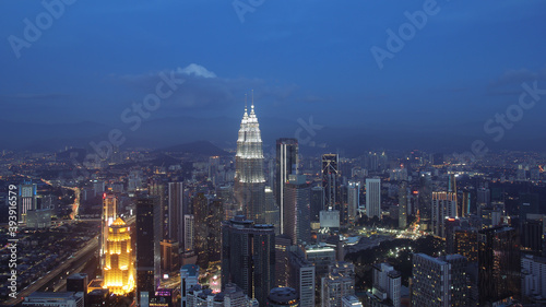Petronas Towers  colorful vibrant twilight after sunset. Panoramic night scene of Kuala Lumpur  Malaysia  Asia. Image is ideal for background. Toned image.