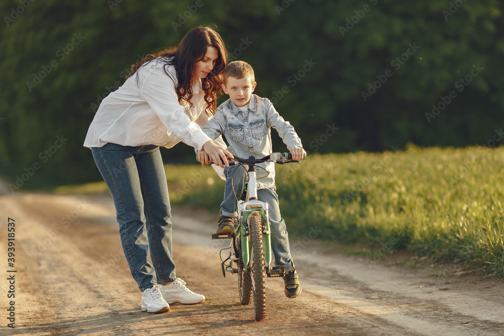 Family in a autumn park. Mother in a white shirt. Cute little boy Family in a autumn park. Mother in a white shirt. Cute little boy