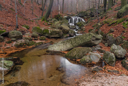 Maly Bily Stolpich waterfall in autumn fresh morning in Jizerske mountains photo