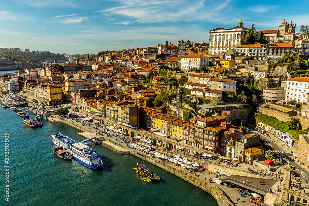 The shoreline of the Douro river in the old quarter of Porto, Portugal on a sunny afternoon