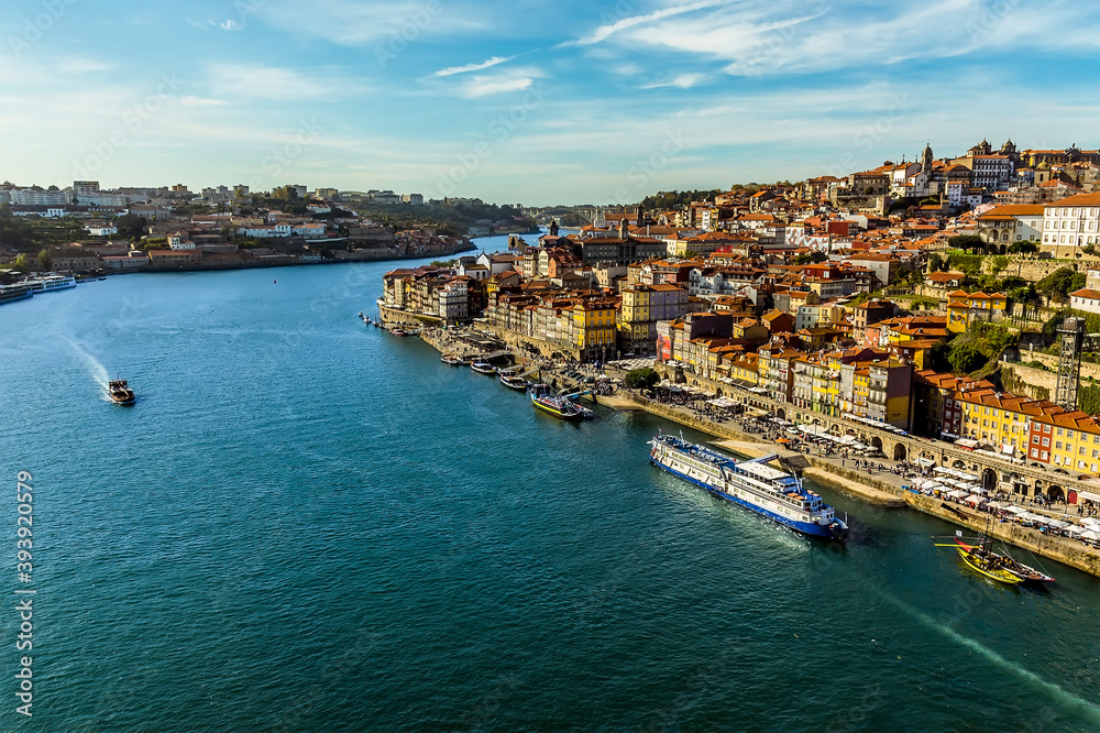 The shoreline of the Douro river and the old quarter of Porto, Portugal on a sunny afternoon