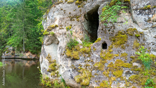 Anfabrika Rocks and Cellars in Ligatne Town an Old Floodgate Dam. Ancient Sandstone Caves and Ancient Chambers in Gauja National Park, Latvia photo