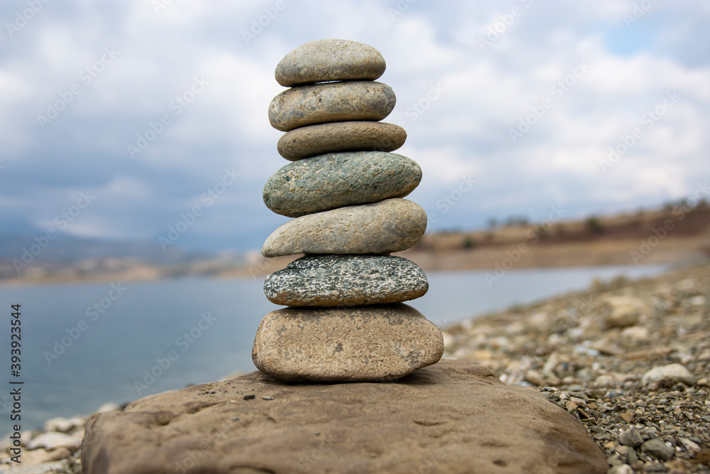Perfect gravel balance on the seashore. Balance, harmony and meditation concept. Aiding or supporting someone to grow or rise. Perfect gravel balance on the seashore. Balance, harmony and meditation concept. Aiding or supporting someone to grow or rise.