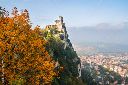The tower of Fortress of Guaita on Monte Titano mountain - the highest in Republic of San Marino. Autumn landscape view overlooking the Valdragone city.