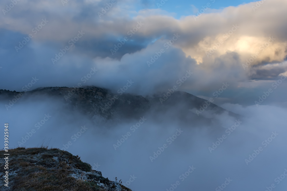 Atmospheric landscape with huge clouds over the mountain. Dramatic skies enveloped the mountains. Sad autumn landscape before the rain. Crimean nature reserve view from the gazebo of winds.