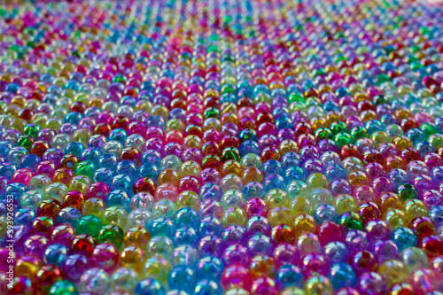 Set of transparent, shiny and many-coloured beads looking like soap bubbles. Seed beads for use in necklaces and bracelets.