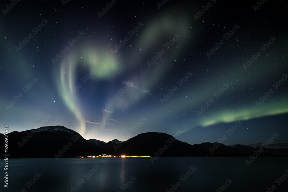 Heart-shaped aurora above mountains