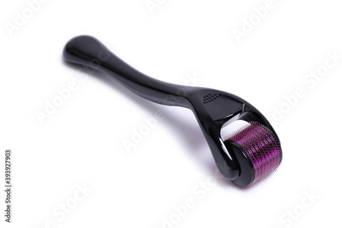 Derma roller mesoroller isolated on a white background. The device for cosmetic procedures of mesotherapy. photo
