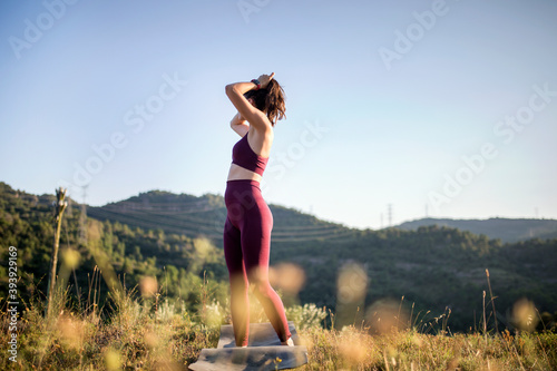 Fototapeta Naklejka Na Ścianę i Meble -  Women practicing yoga in nature