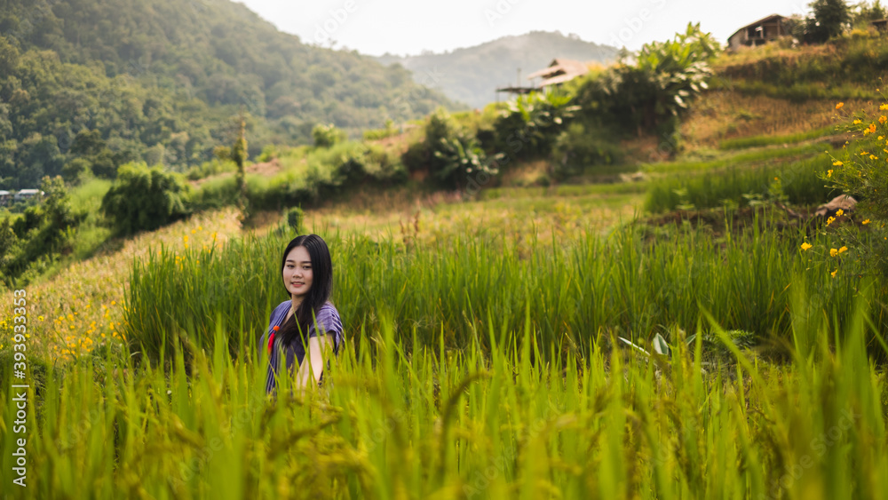 Asian woman smile and stand on  Rice terraces in Pa Bong Piang , Chiang Mai , Thailand.