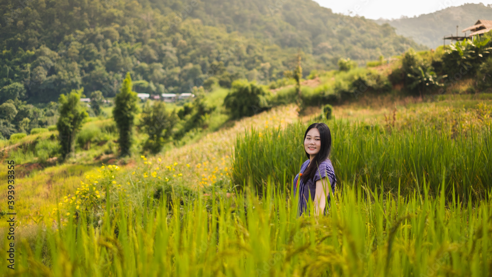 Asian woman smile and stand on  Rice terraces in Pa Bong Piang , Chiang Mai , Thailand.