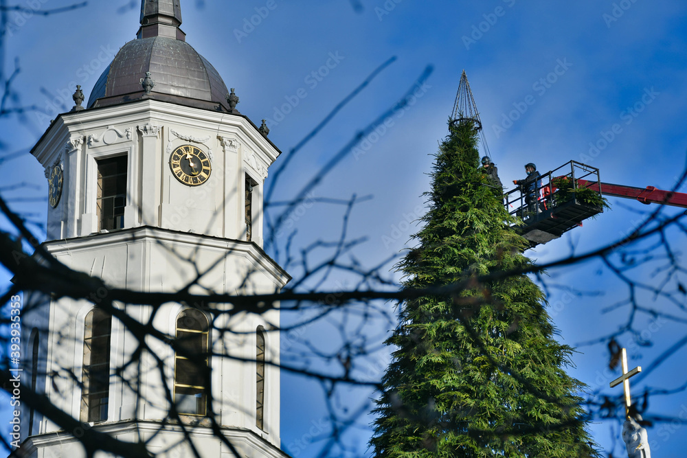 Men at work on the top of a Christmas tree, city crews begin construction with a crane, preparing and decorating the city for Christmas, all events and market cancelled due to Covid or Coronavirus
