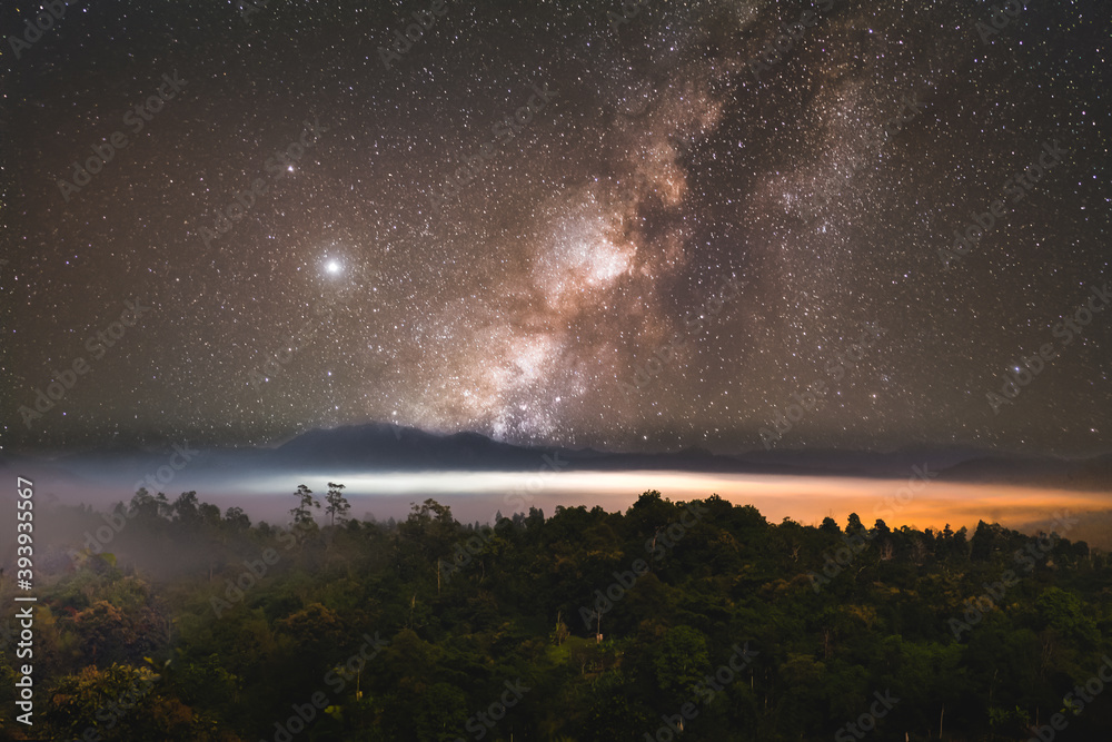 Milky Way above mountain and fog at night sky. Beautiful landscape in Mae Hong Son Province, Thailand