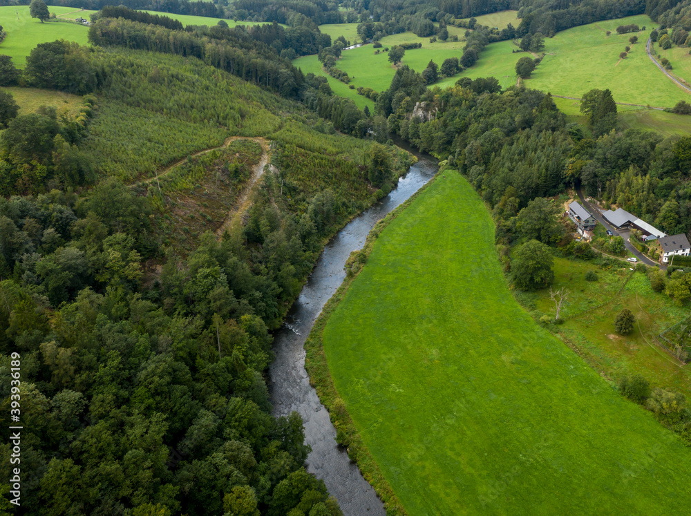 Small river in a green rural landscape; aerial view
