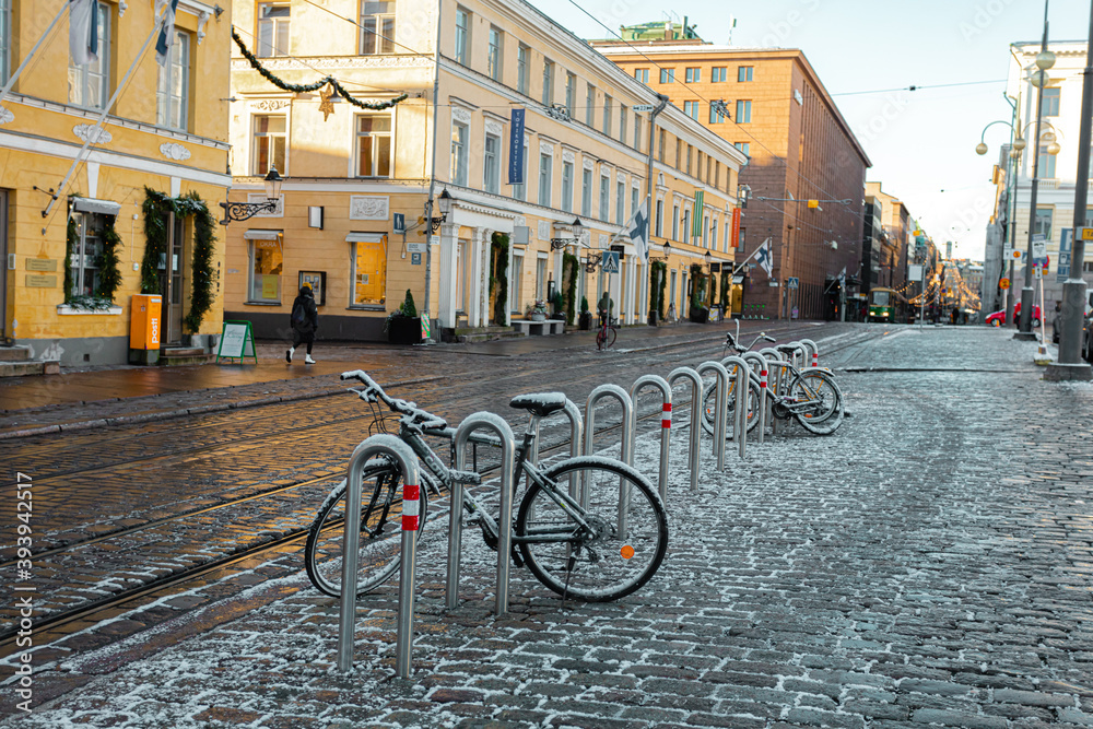 Helsinki, Finland November 20, 2020 Downtown Helsinki, Senate Square, bicycles covered in snow, sunny day in November.