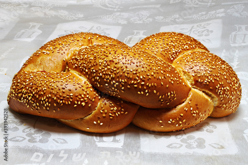 Challah -  Jewish Bread, traditionally baked to celebrate the Shabbat. The inscriptions on the tablecloth translated from Hebrew means Shabbat Shalom (peaceful Saturday), Jewish holiday, Israel photo