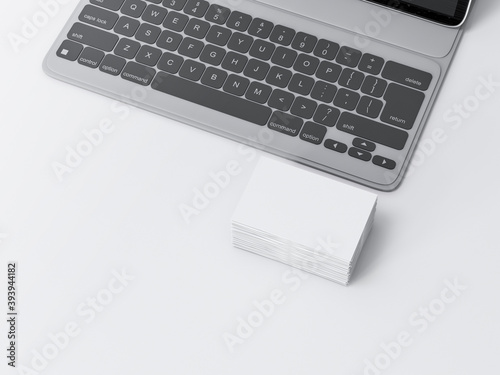 Stack of White Business Cards Mockup on white table with laptop in office