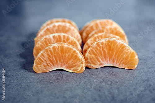 A shot of tangerine pieces on a rough surface