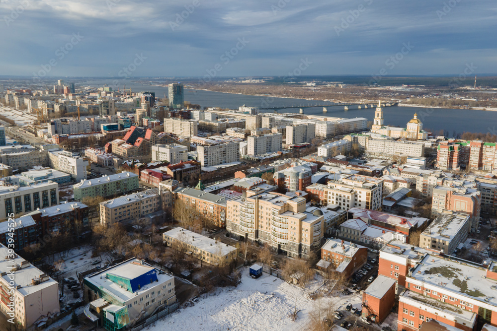 Aerial view of Perm city in winter sunny day, lots of buildings and river Kama in the background