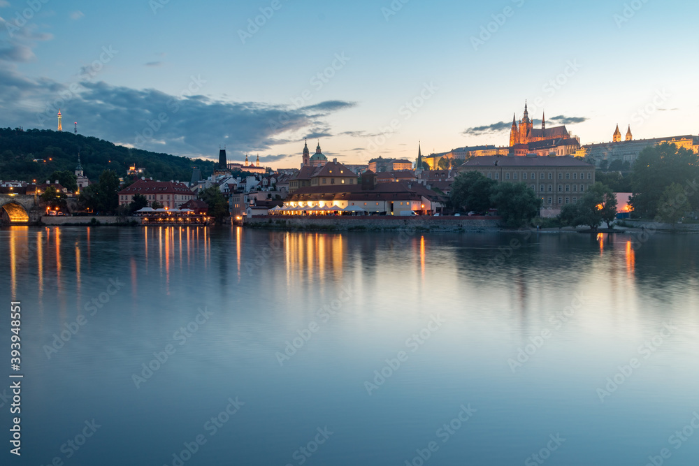 Vltava river and hill in old town of Prague at sunset time.