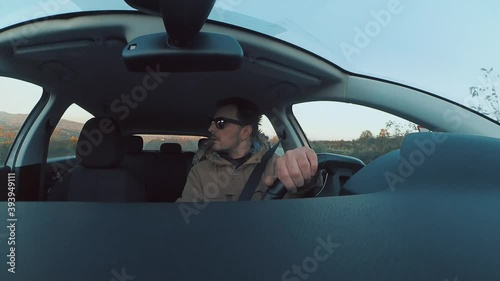 Attractive young man reversing a car