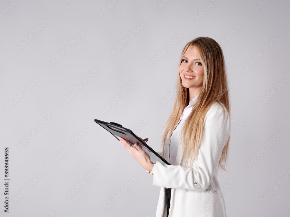 Young business woman taking notes in a folder Young business woman taking notes in a folder