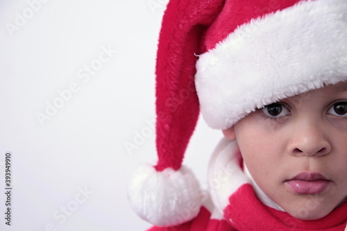 little boy with Christmas hat on his head with white background stock photo
