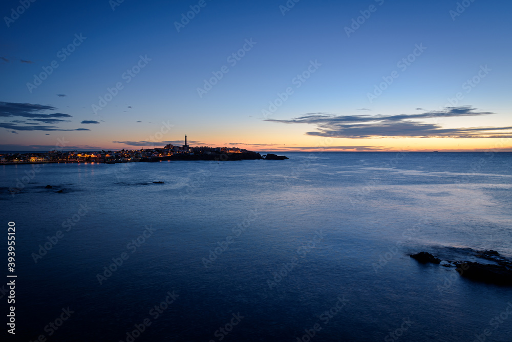 Fototapeta premium Seascape of the mediterranean sea and Cabo de Palos city in the background at sunset, Murcia, Spain