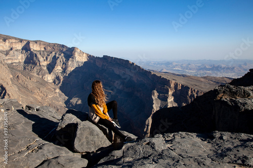Woman admiring the Jebel Shams canyon in Oman