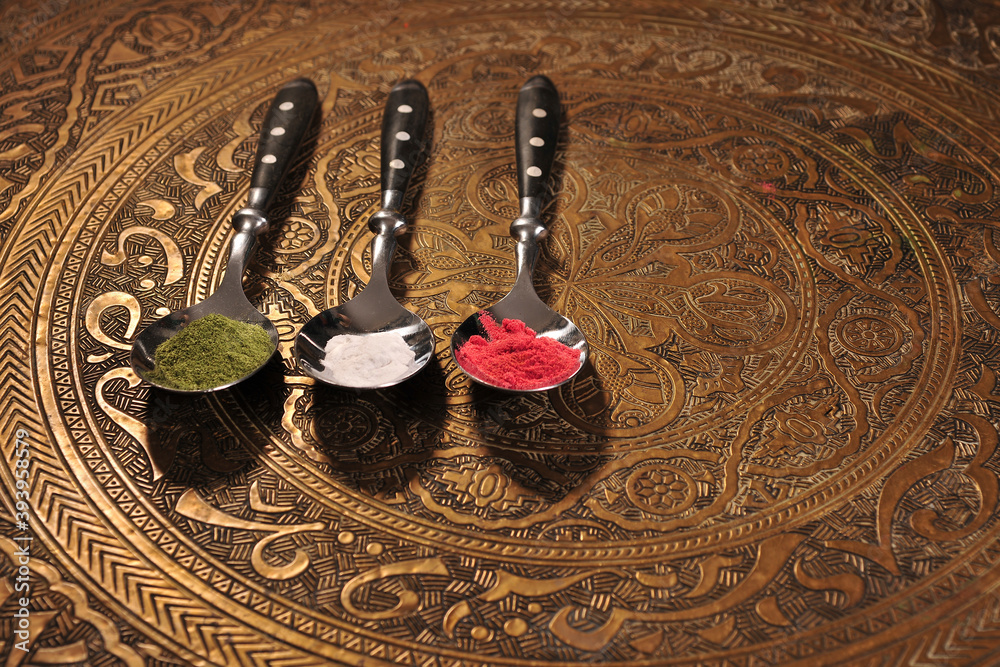 rustic spoons with colorful spices