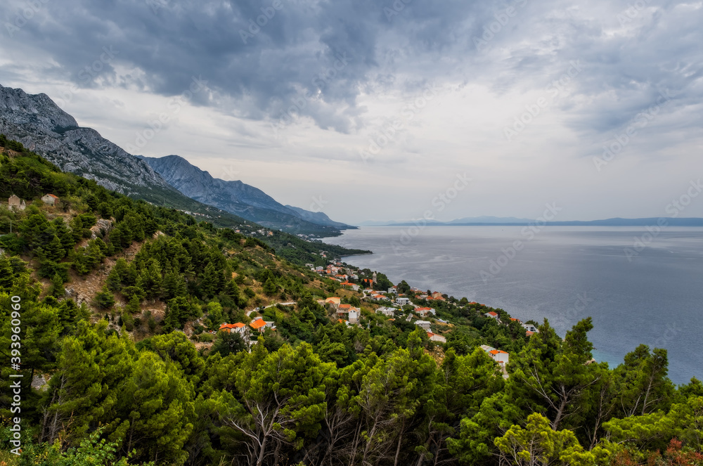 Looking down to the town of Brela on the Adriatic coastline of Croatia. Cloudy august day, 2020