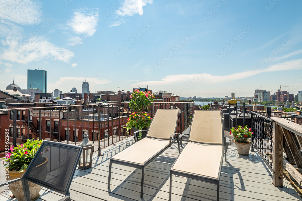 A roof deck looks down on Beacon Hill and the Boston skyline