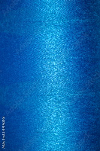 Blue thread texture. Close-up of the thread wound on a spool.
