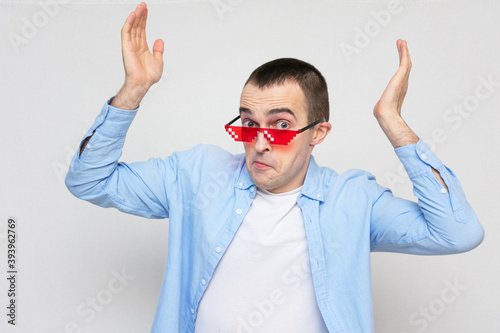 Puzzled film fan with pixel glasses, portrait, white background