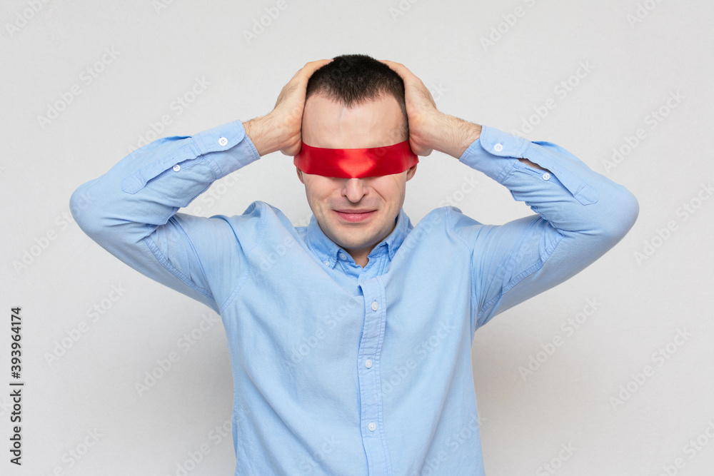 Frustrated man grabbed his head, guy can't solve a difficult task, red blindfold, portrait, white background, copy space Frustrated man grabbed his head, guy can't solve a difficult task, red blindfold, portrait, white background, copy space