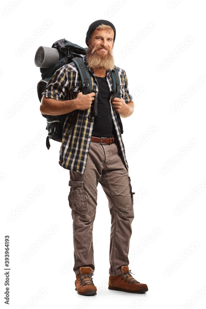 Full length portrait of a young bearded tourist with a backpack smiling at camera Full length portrait of a young bearded tourist with a backpack smiling at camera