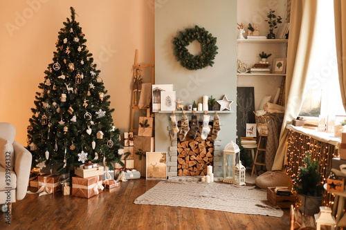 Christmas interior of a living room with a sofa decorated with a Christmas tree, fireplace, gifts and a big bright star in warm colors in a cozy home