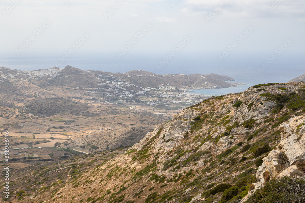A view of the hazy west coast of Ios Island. Chora town and port in the background. Cyclades, Greece