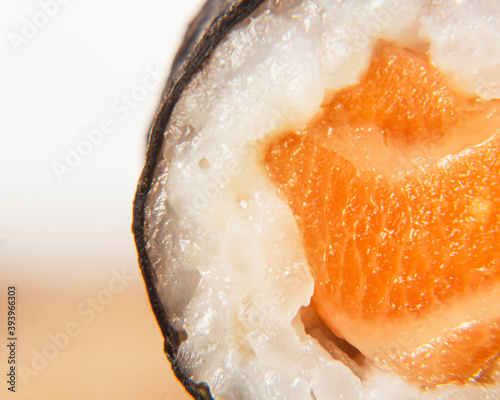 Closeup shot of fresh sushi roll on blurred background photo