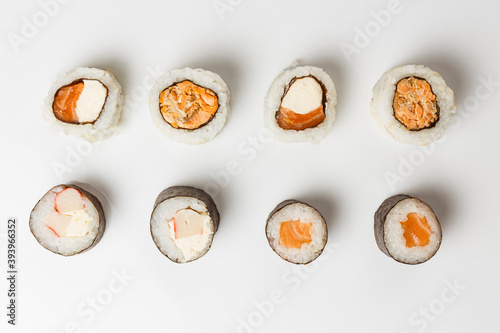 Top view of fresh sushi rolls on white background photo