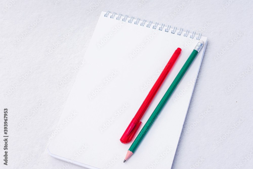 Pencil, pen and notebooks, white background, top view, copy space Pencil, pen and notebooks, white background, top view, copy space
