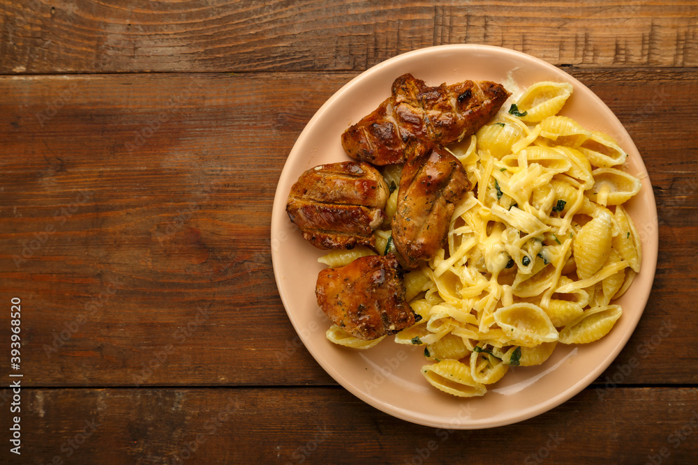 Plate of pasta in creamy sauce with cheese and chicken copy space