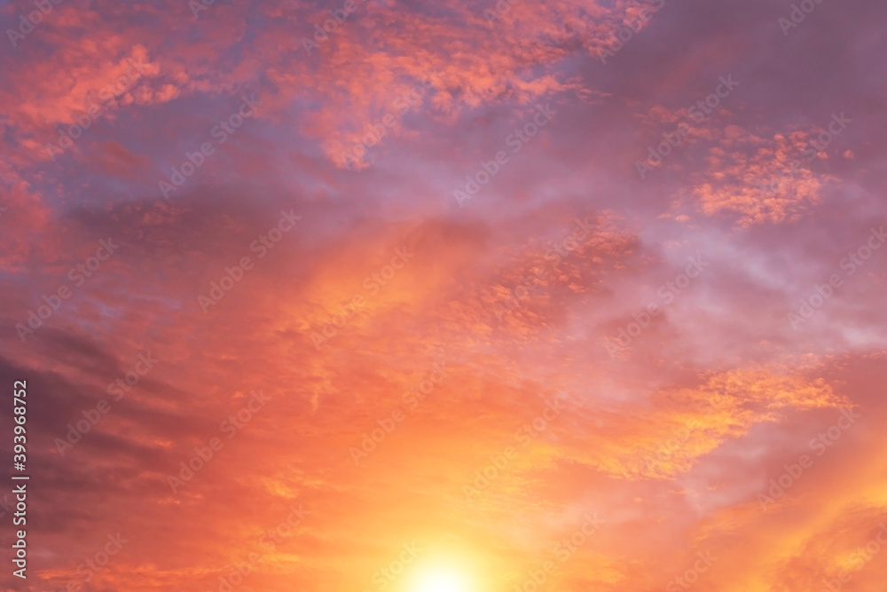Soft sunrise, sunset pink violet orange sky with sun, clouds