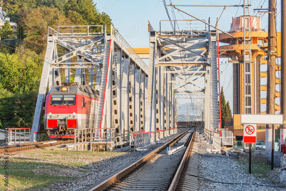 Passenger train moves through the bridge. Sochi.. Passenger train moves through the bridge. Sochi..