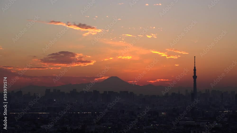 TOKYO, JAPAN : Aerial high angle sunrise CITYSCAPE of TOKYO and MOUNT FUJI. View of rising sun and buildings at downtown area. Japanese city life and nature concept. Time lapse shot night to morning. TOKYO, JAPAN : Aerial high angle sunrise CITYSCAPE of TOKYO and MOUNT FUJI. View of rising sun and buildings at downtown area. Japanese city life and nature concept. Time lapse shot night to morning.