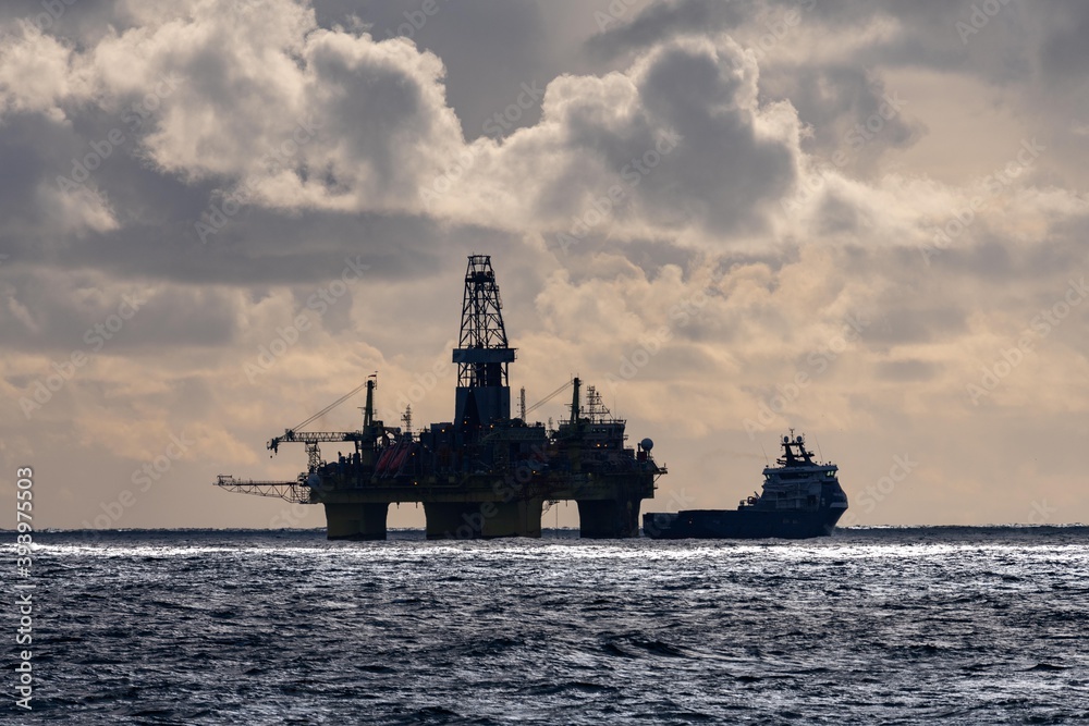 oil rig and supply vessel in north sea oil rig and supply vessel in north sea