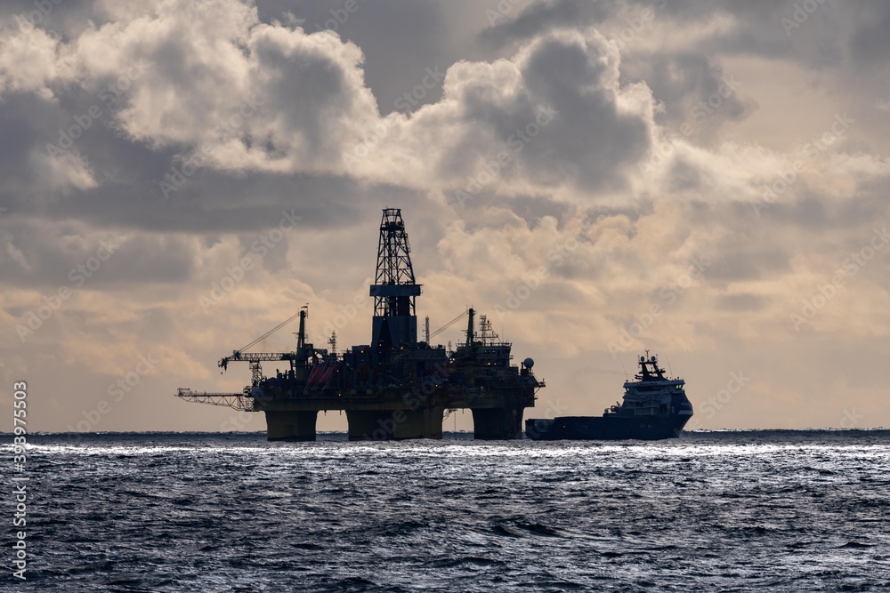 oil rig and supply vessel in north sea