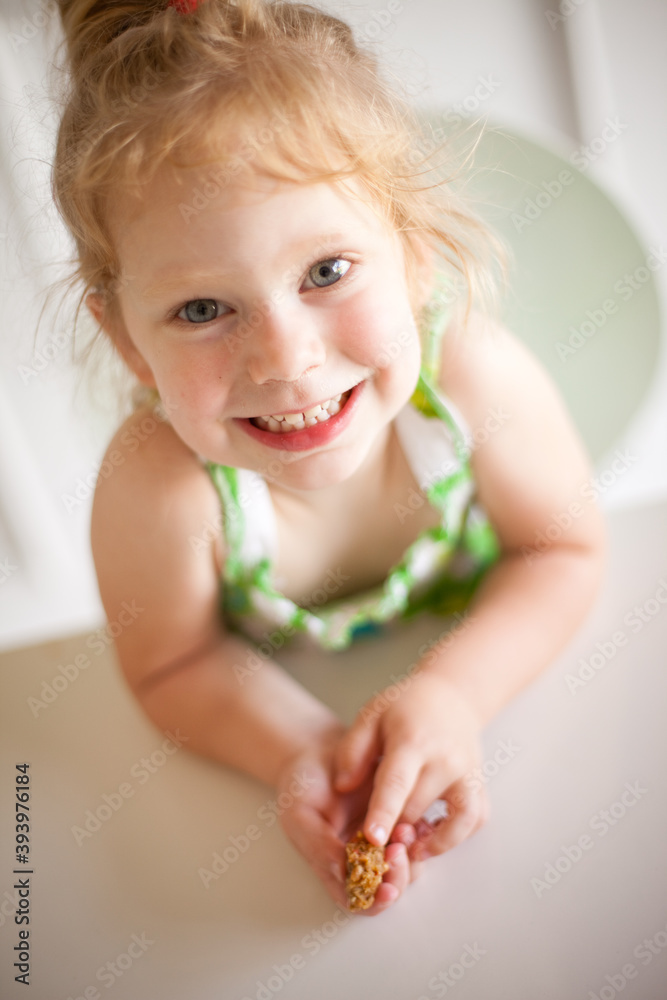 Happy Little Girl Smiling at Dining Room Table at Home, Childhood Lifestyle Portrait Happy Little Girl Smiling at Dining Room Table at Home, Childhood Lifestyle Portrait